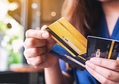 Person dealing with multiple credit cards and debt