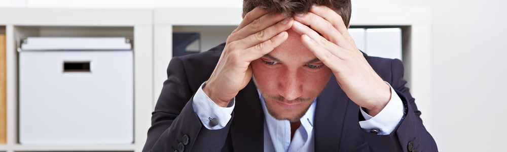 Stressed person calculates finances, faced with collection agency notices due to co-signing an auto loan and the primary signer defaulting.