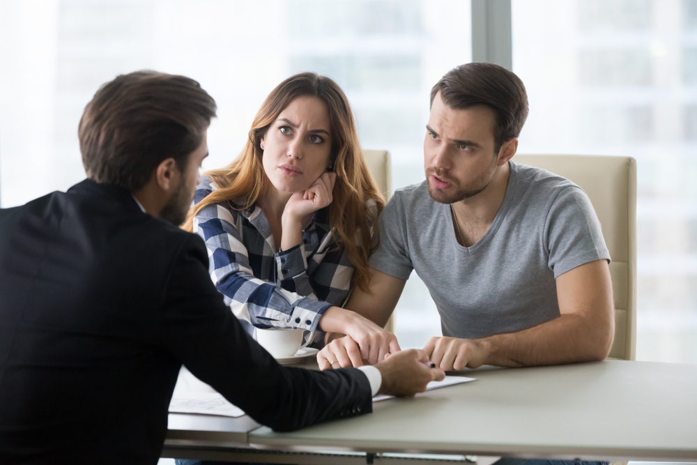 Couple discussing financial concerns with a professional