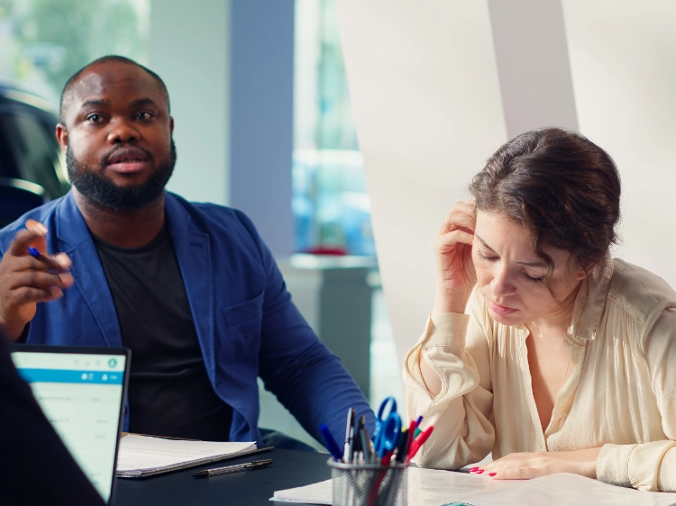 Couple talking with a bankruptcy lawyer about Chapter 7 debt relief options