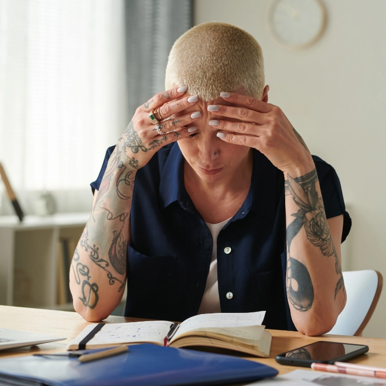 Woman looking worried while reviewing bills and paperwork for Chapter 7 bankruptcy help